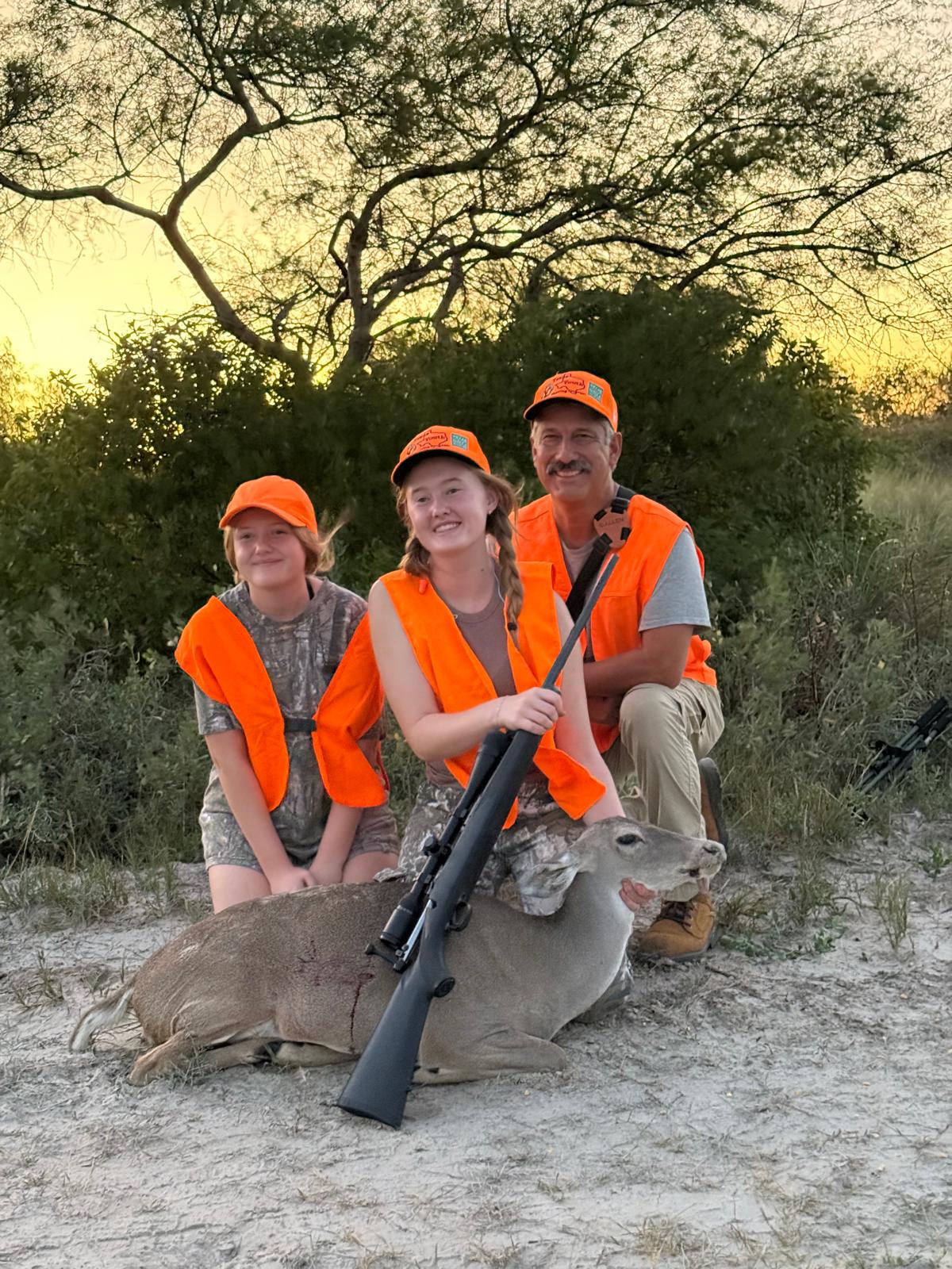 Two young hunters and an adult together after a hunt